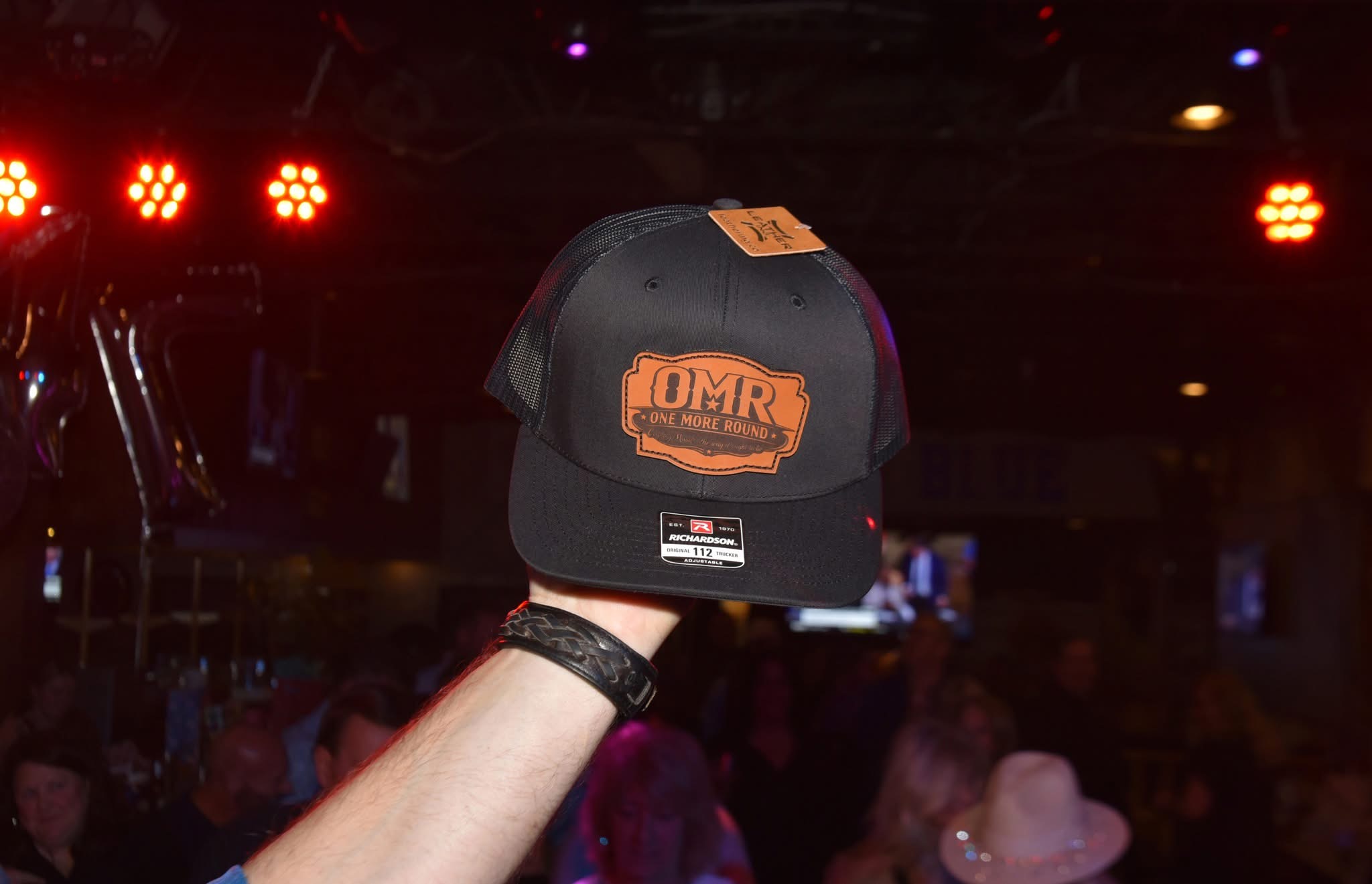 One More Round black Richardson trucker hat with OMR leather-style patch
